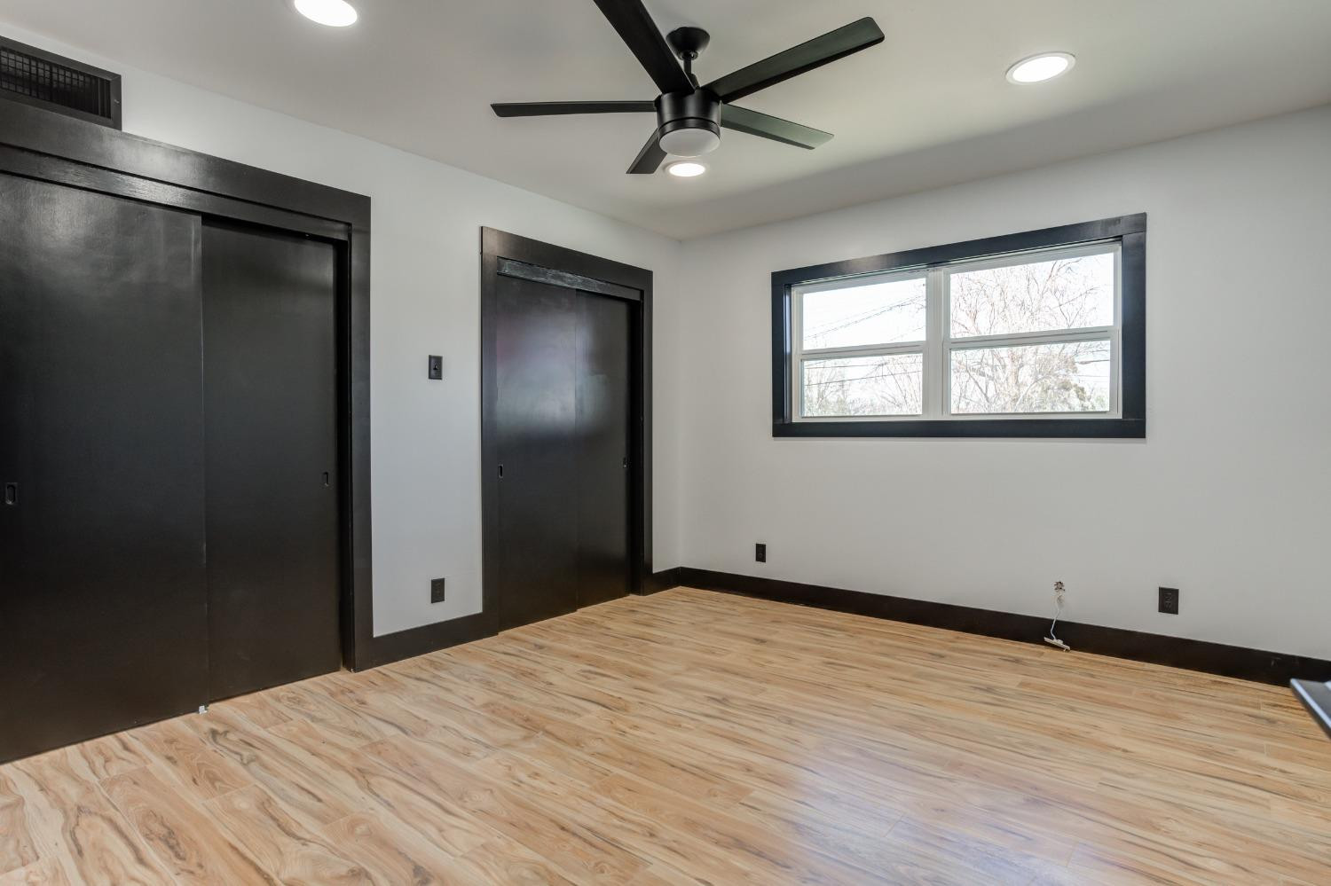3410 40th Street Lubbock, TX 79413 - Photo 24 of 45 a view of empty room with wooden floor and fan