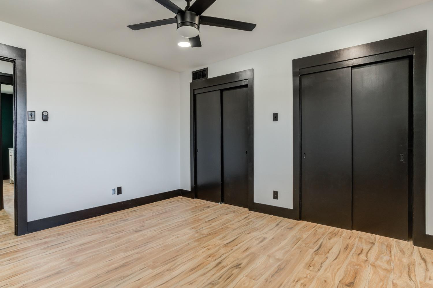 3410 40th Street Lubbock, TX 79413 - Photo 25 of 45 a view of empty room with wooden floor and fan
