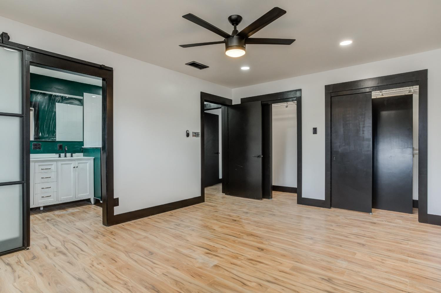 3410 40th Street Lubbock, TX 79413 - Photo 29 of 45 a view of empty room with wooden floor and ceiling fan