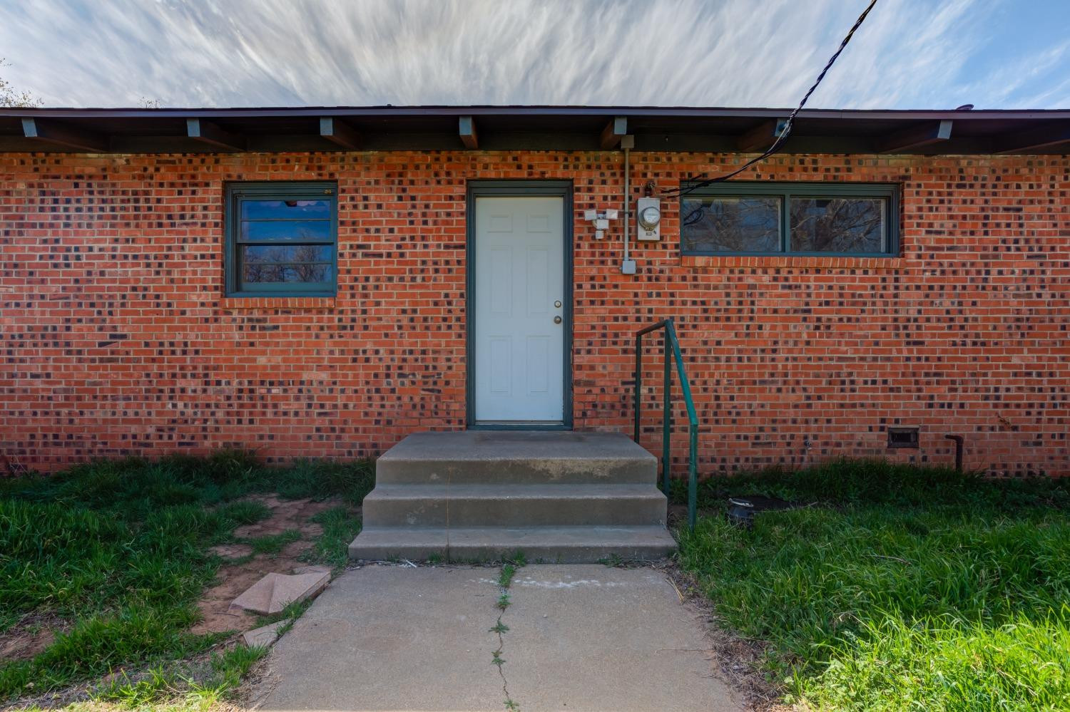 3410 40th Street Lubbock, TX 79413 - Photo 33 of 45 a view of front door of house with a yard