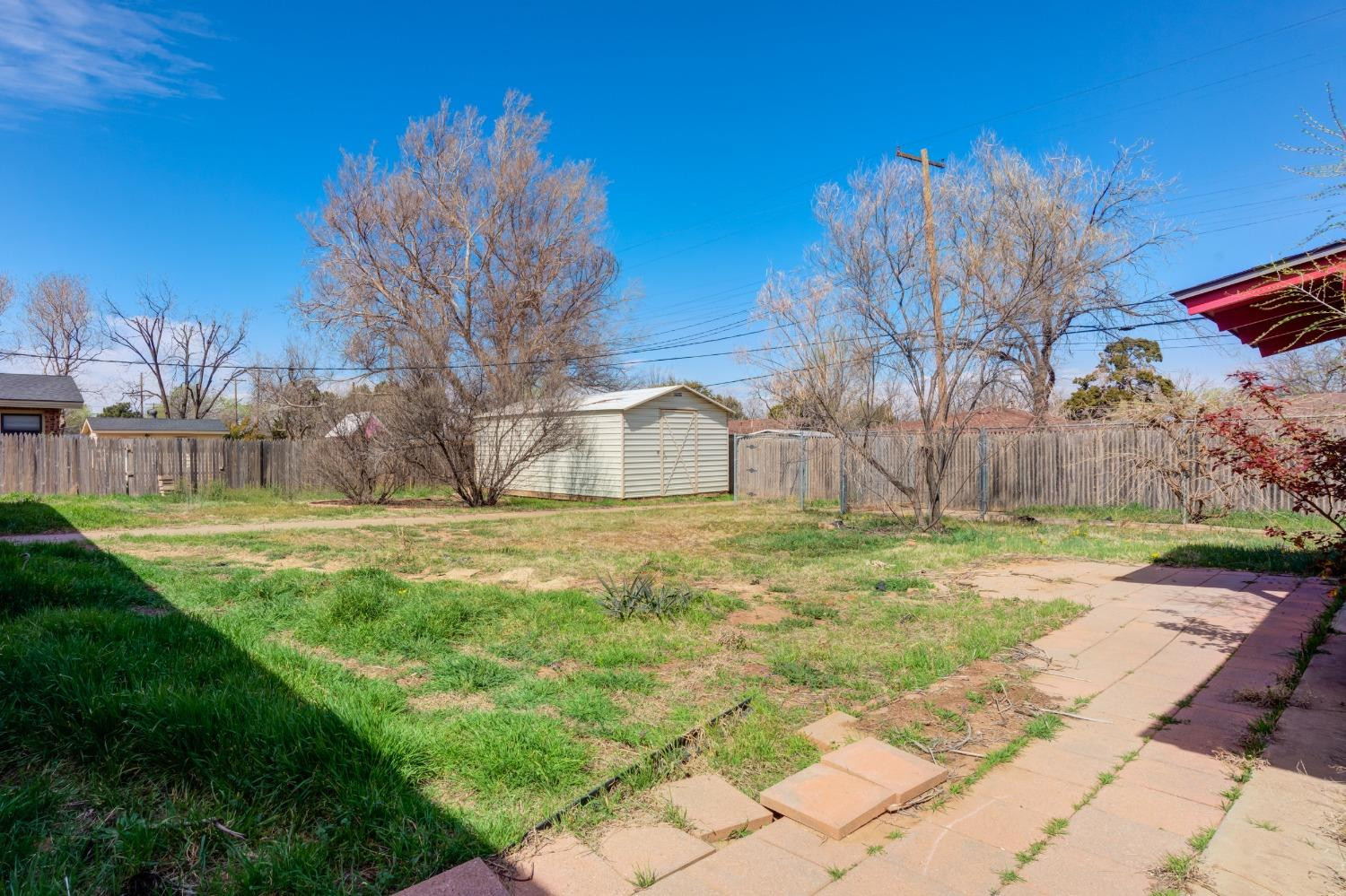 3410 40th Street Lubbock, TX 79413 - Photo 35 of 45 a backyard of a house with lots of green space