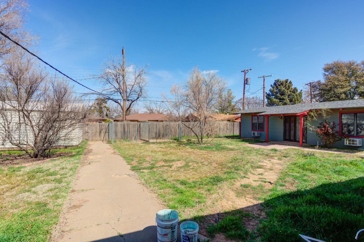 3410 40th Street Lubbock, TX 79413 - Photo 36 of 45 a front view of house with yard and trees in the background