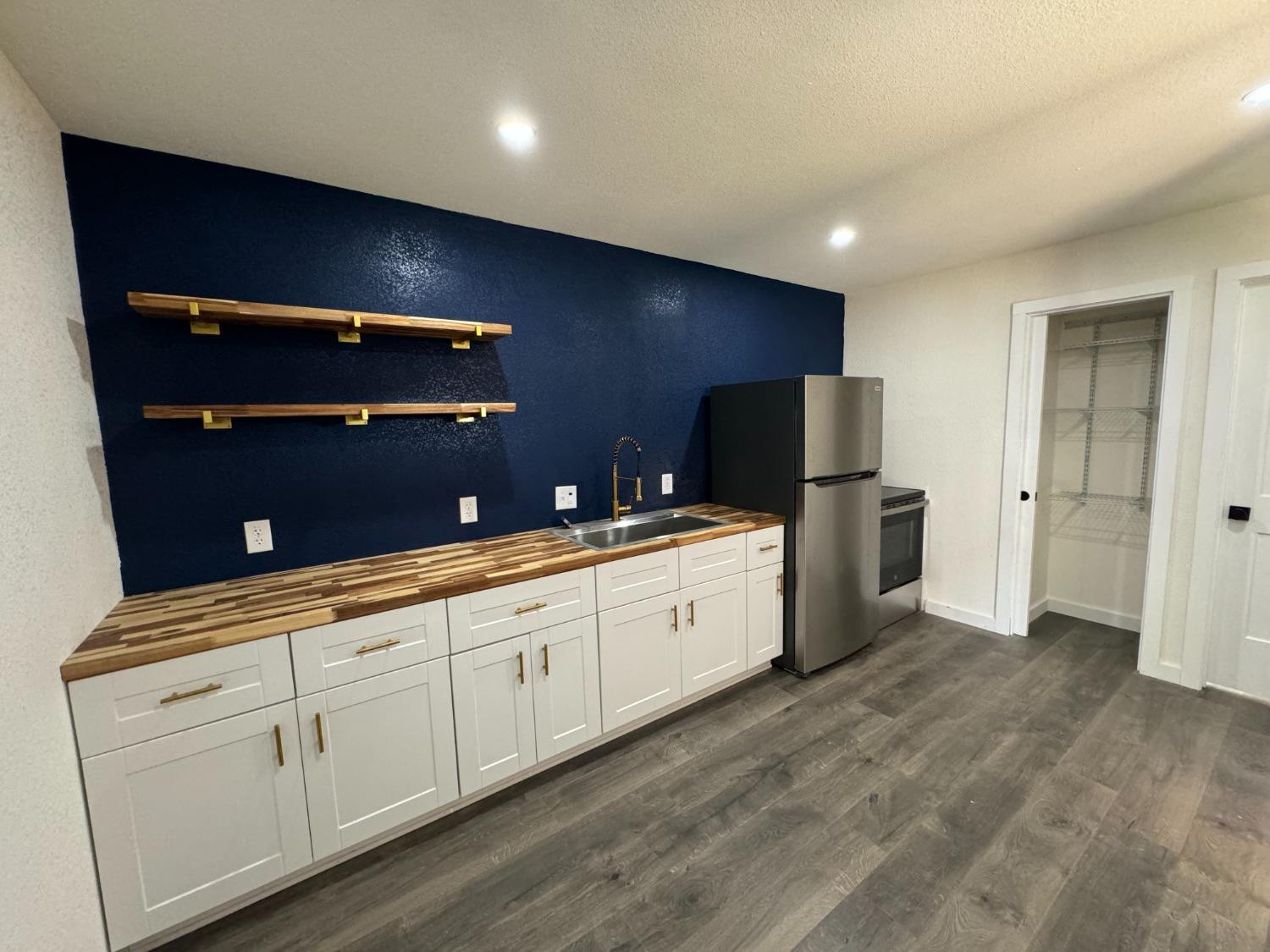 3410 40th Street Lubbock, TX 79413 - Photo 38 of 45 a large white kitchen with stainless steel appliances granite countertop a refrigerator and a sink