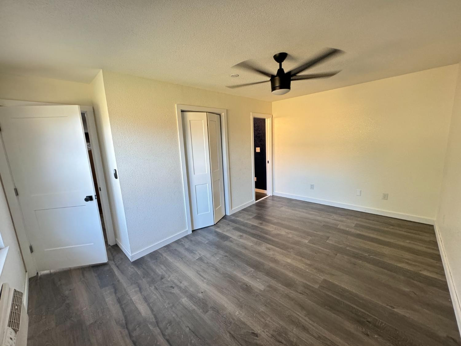 3410 40th Street Lubbock, TX 79413 - Photo 40 of 45 a view of a livingroom with wooden floor and a ceiling fan