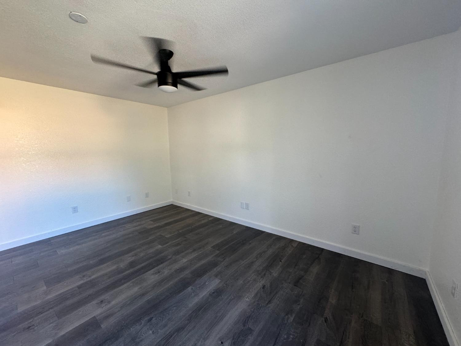 3410 40th Street Lubbock, TX 79413 - Photo 42 of 45 a view of a room with wooden floor and a ceiling fan