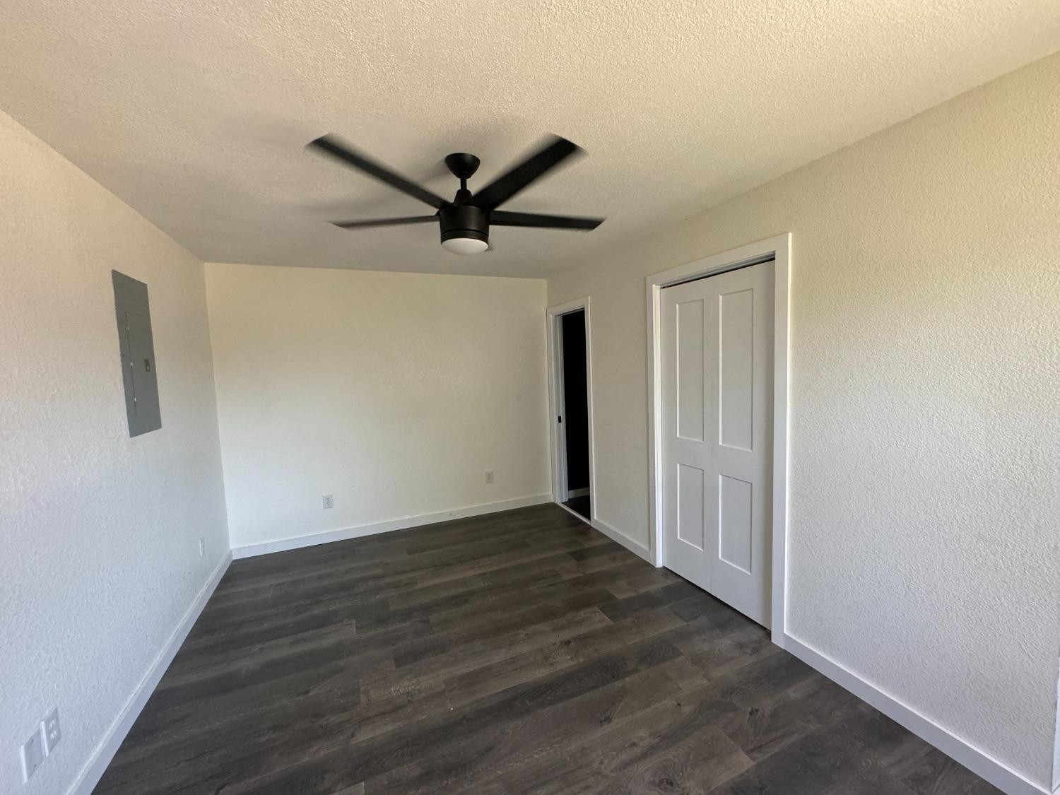 3410 40th Street Lubbock, TX 79413 - Photo 43 of 45 a view of a big room with wooden floor and a ceiling fan