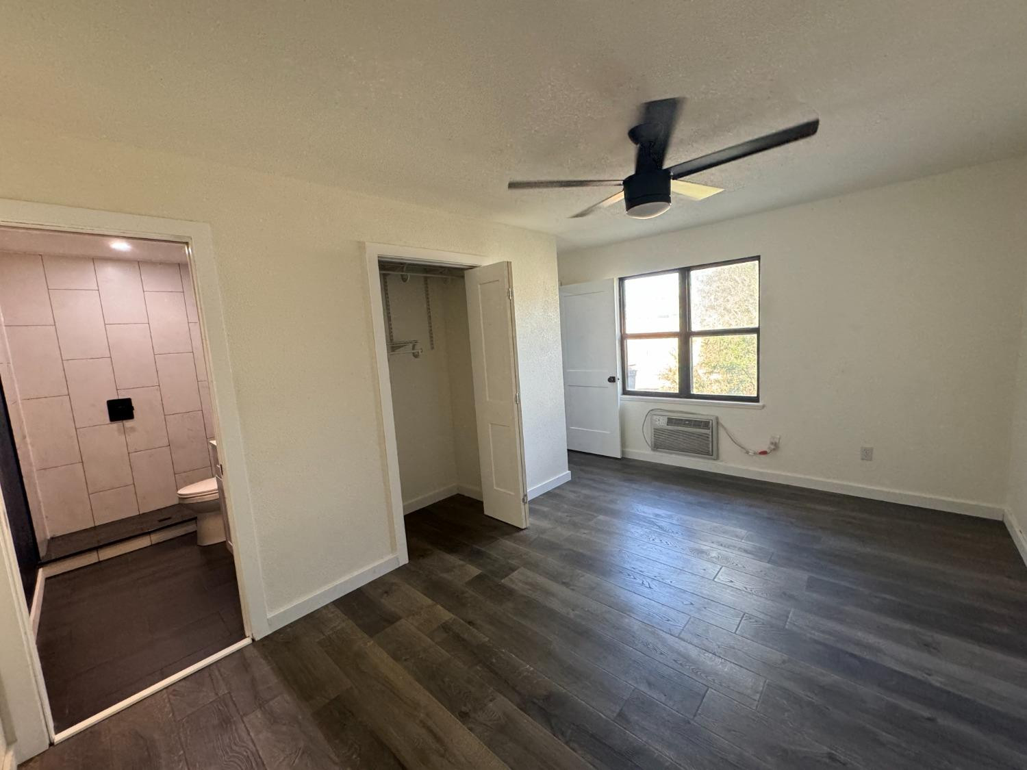 3410 40th Street Lubbock, TX 79413 - Photo 44 of 45 an empty room with wooden floor cabinet and windows