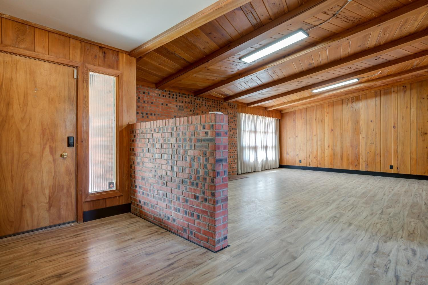 3410 40th Street Lubbock, TX 79413 - Photo 5 of 45 a view of an empty room with wooden floor and a window