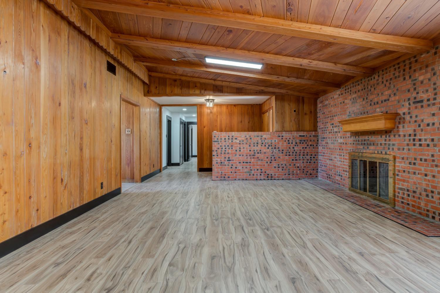 3410 40th Street Lubbock, TX 79413 - Photo 9 of 45 a view of empty room with wooden floor and fireplace