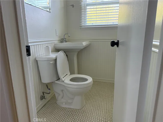 a white toilet sitting next to a small sink
