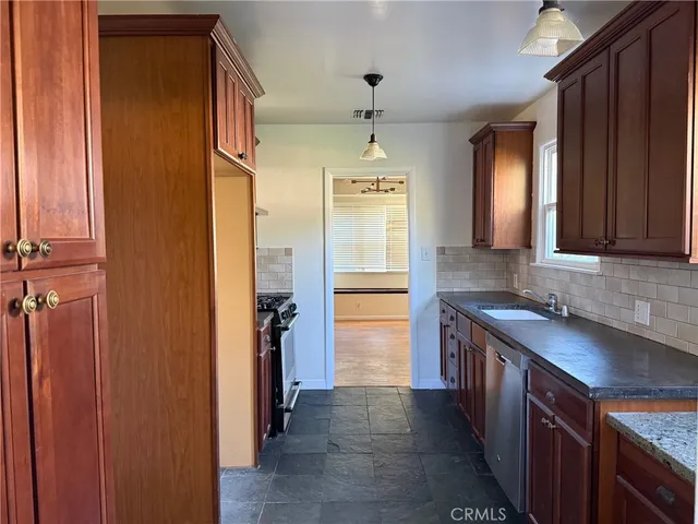 a kitchen with a sink stove and refrigerator