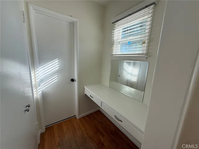 a view of room with window and wooden floor