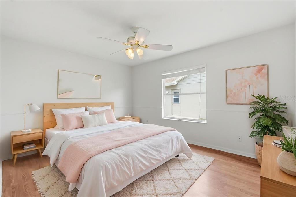 1444 Canberley Court Trinity, FL 34655 - Photo 27 of 52 a bedroom with a large bed chandelier and a window