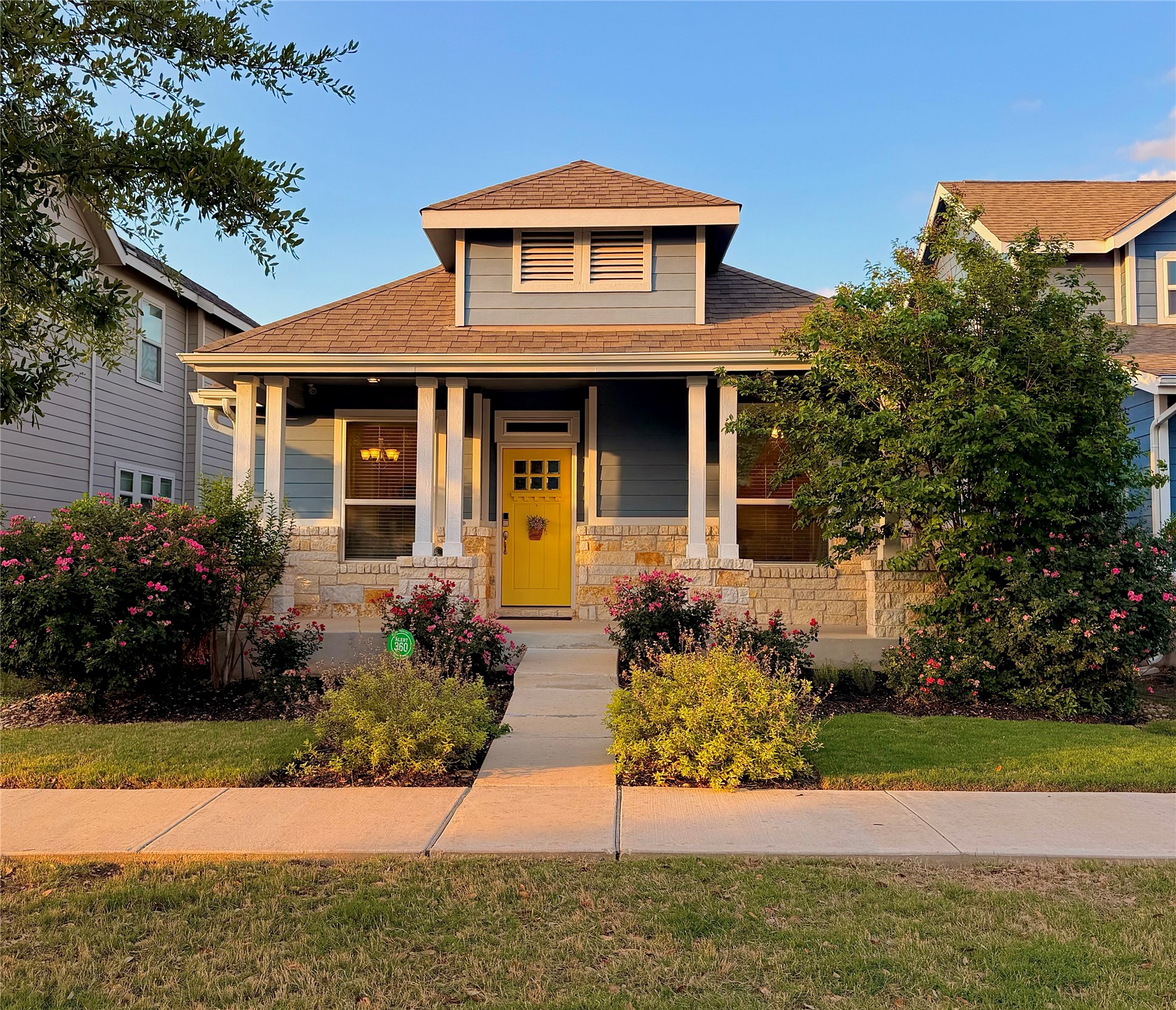 5912 Corrine Lane Austin, TX 78747 - Photo 1 of 27 Bungalow featuring covered porch, stone siding, and a front lawn