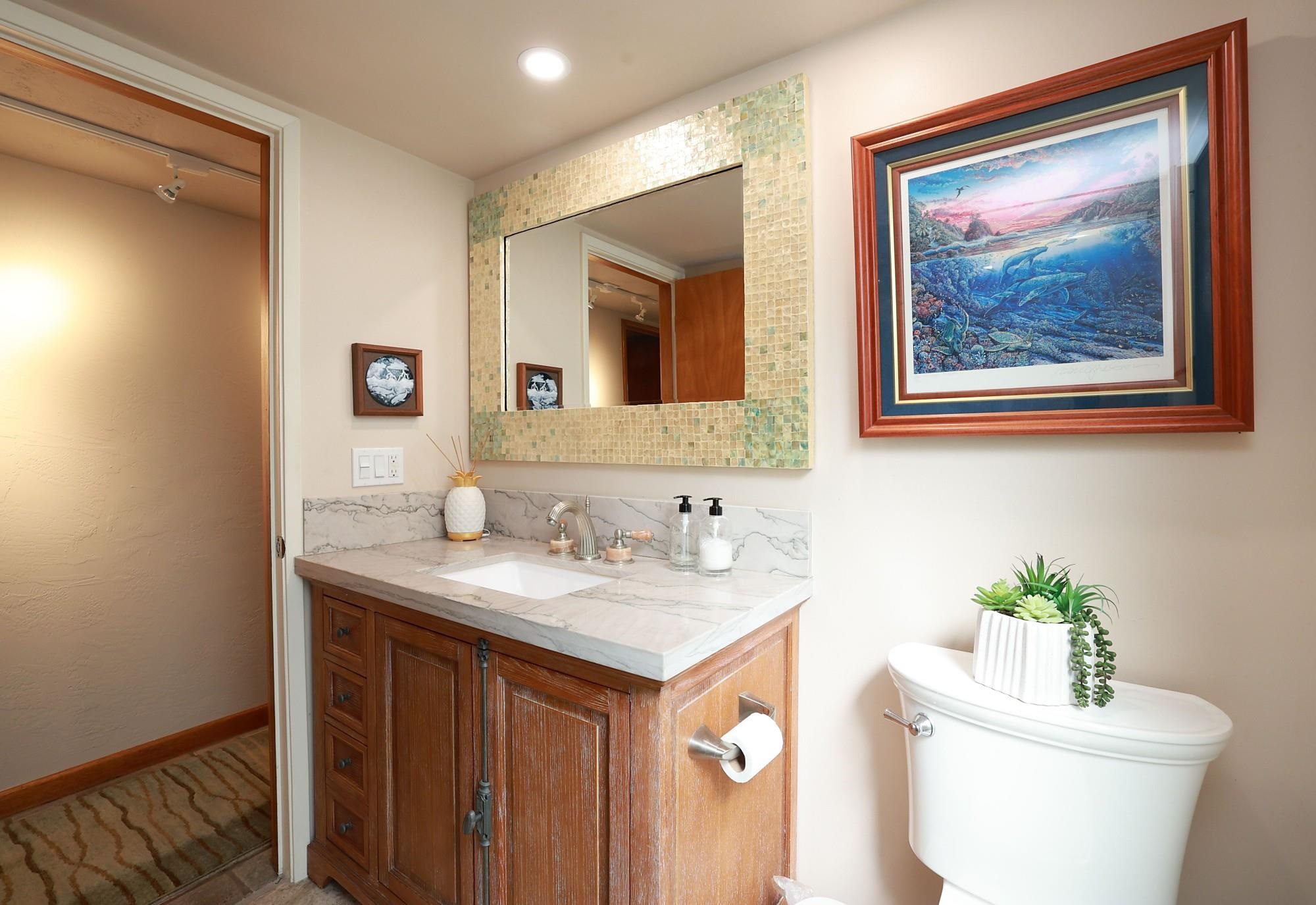 5045 Lower Honoapiilani Road, Unit 2 Lahaina, HI 96761 - Photo 28 of 37 a bathroom with a toilet sink and mirror