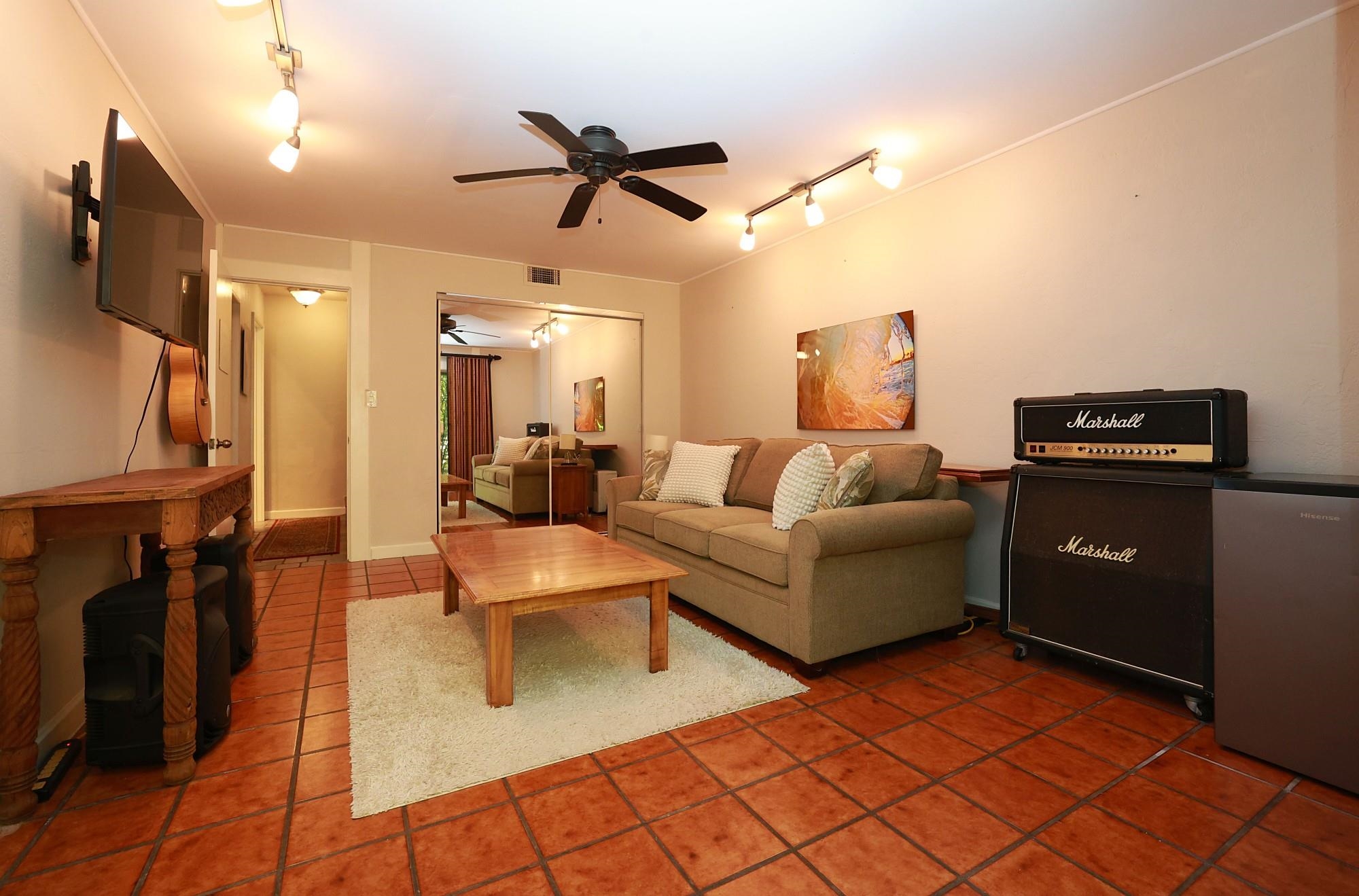 5045 Lower Honoapiilani Road, Unit 2 Lahaina, HI 96761 - Photo 31 of 37 a living room with furniture and a flat screen tv