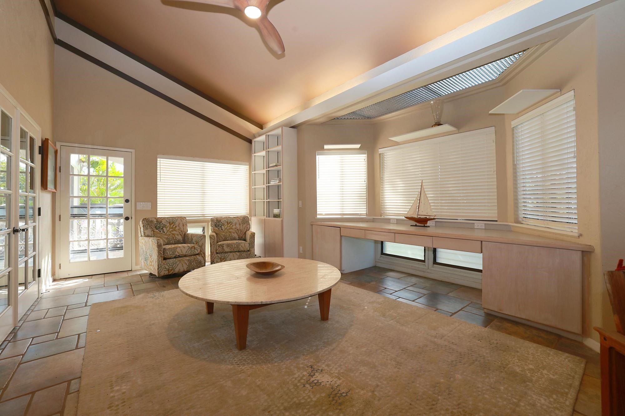 5045 Lower Honoapiilani Road, Unit 2 Lahaina, HI 96761 - Photo 6 of 37 a living room with furniture a window and a table