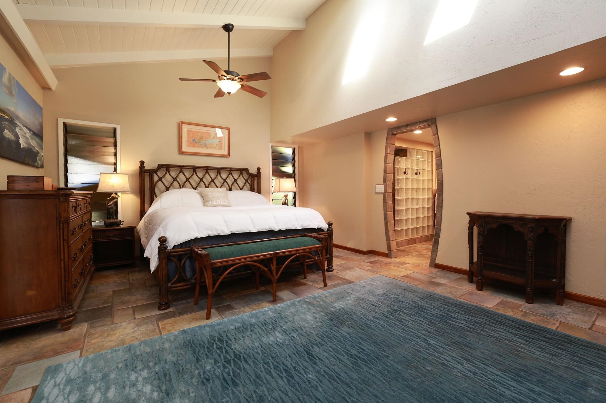 5045 Lower Honoapiilani Road, Unit 2 Lahaina, HI 96761 - Photo 8 of 37 a bed room with a bed and a ceiling fan