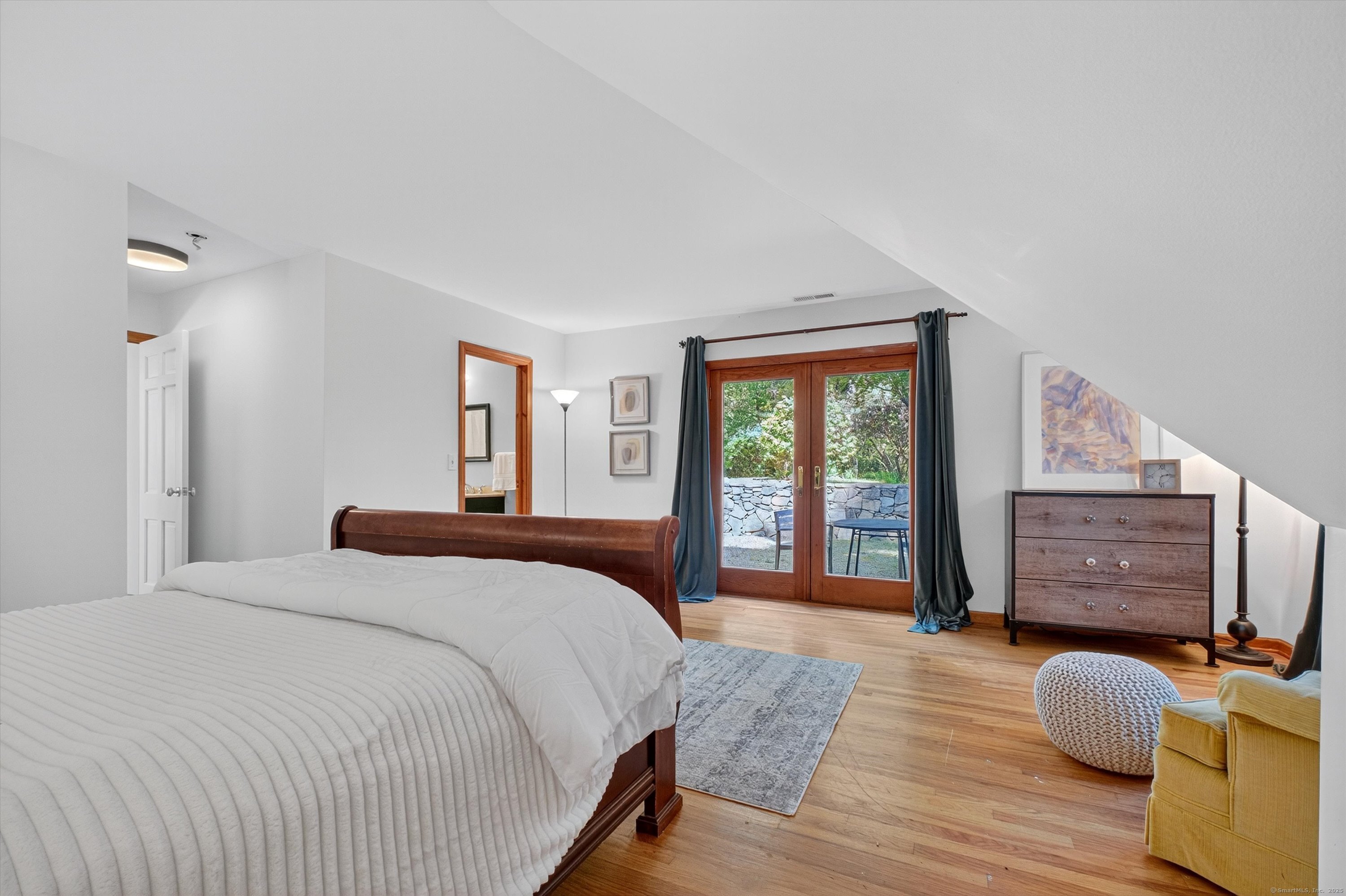 45 Indian Trail Brookfield, CT 06804 - Photo 25 of 40 a bedroom with a bed and wooden floor