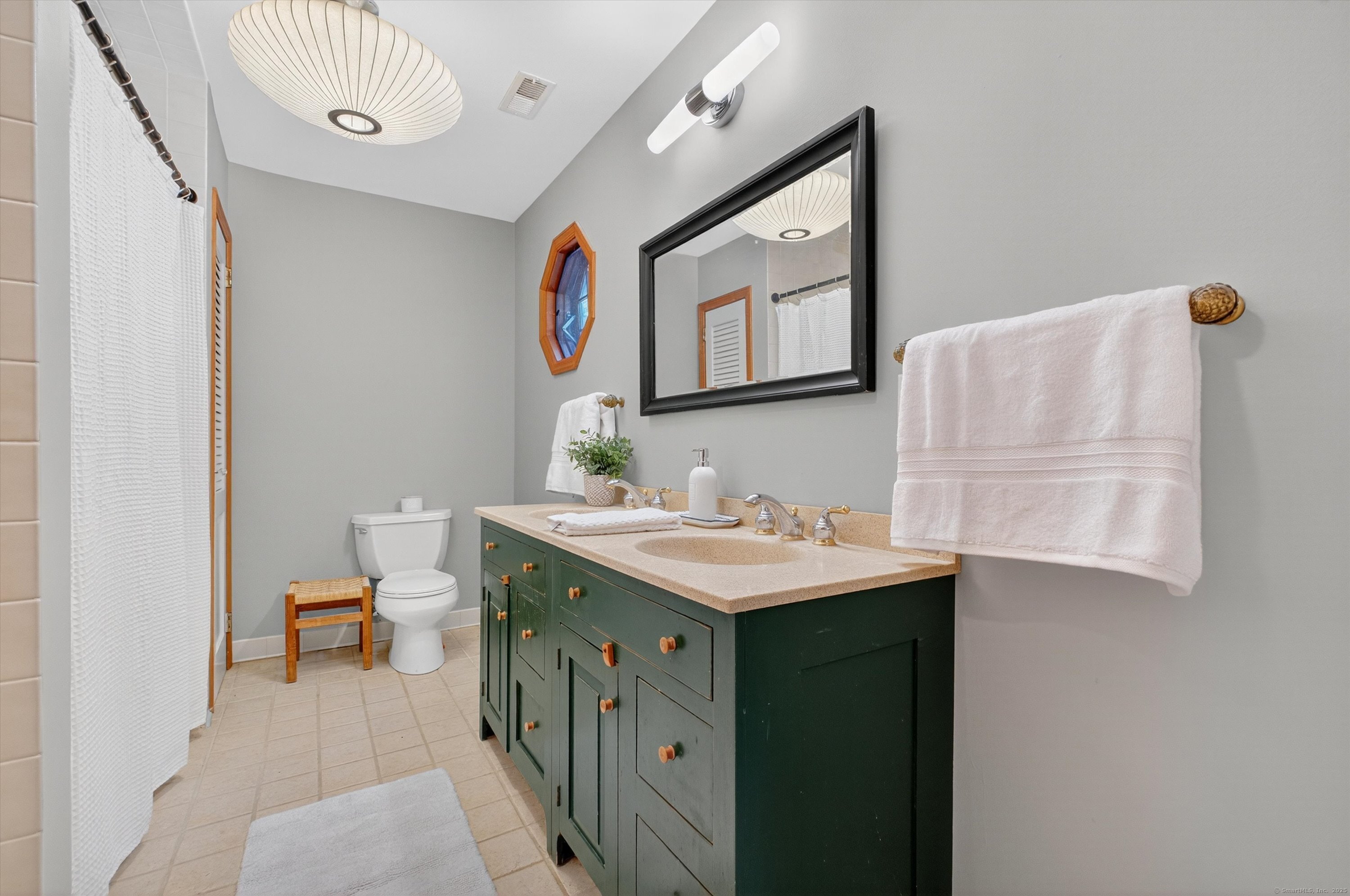 45 Indian Trail Brookfield, CT 06804 - Photo 26 of 40 a bathroom with a sink a vanity and a mirror