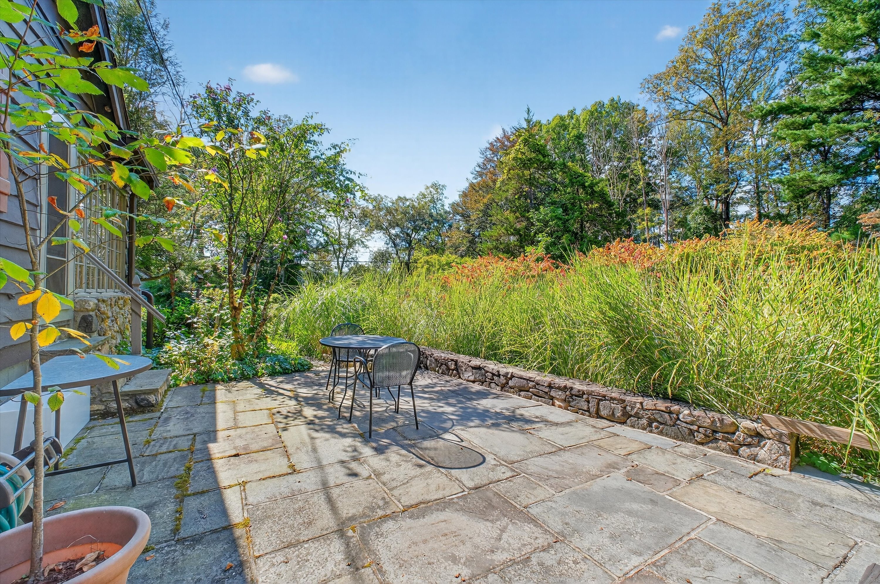45 Indian Trail Brookfield, CT 06804 - Photo 32 of 40 a patio with table and chairs and potted plants