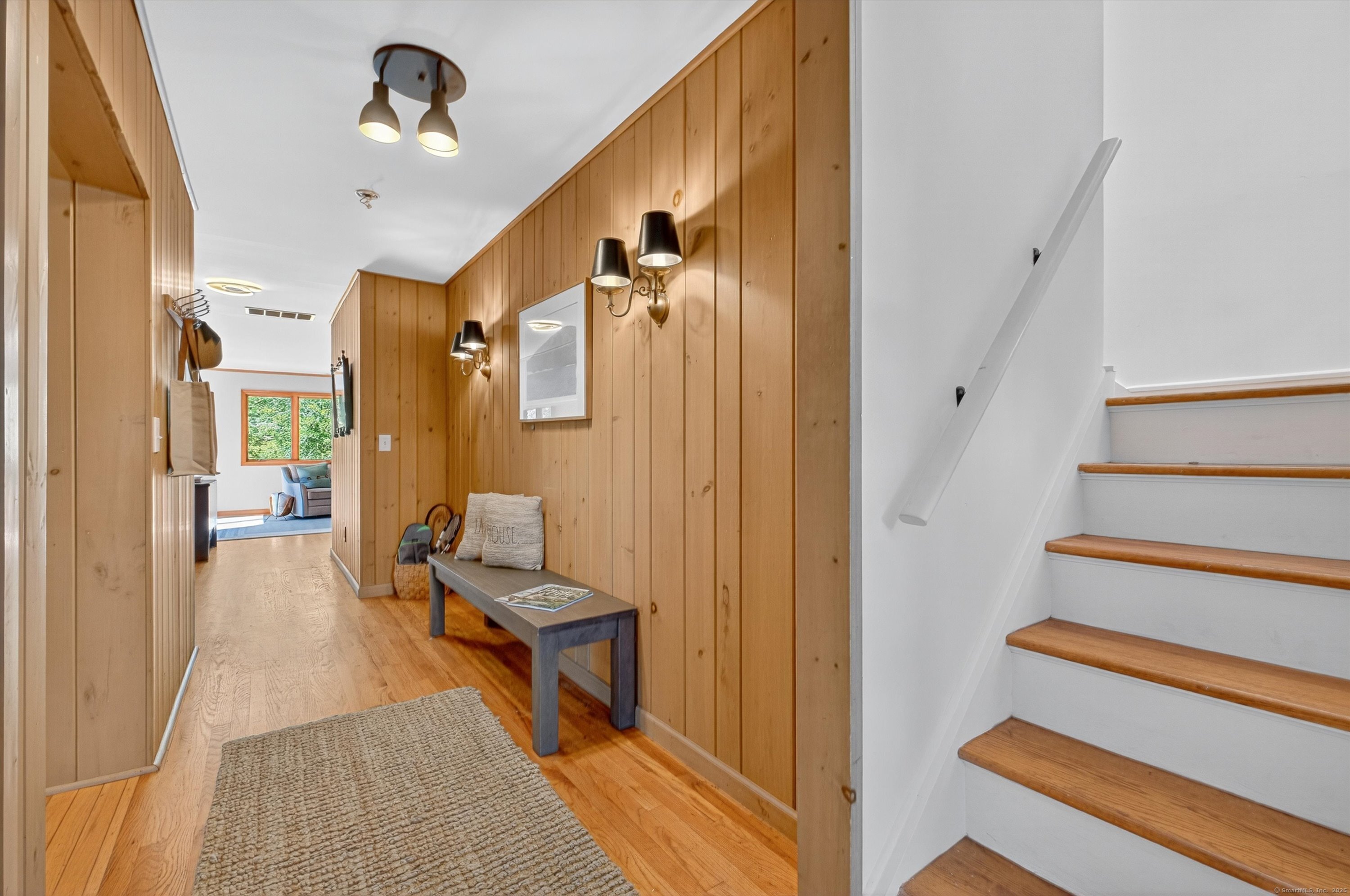 45 Indian Trail Brookfield, CT 06804 - Photo 7 of 40 a view of a hallway with the couches and dinning room with wooden floor