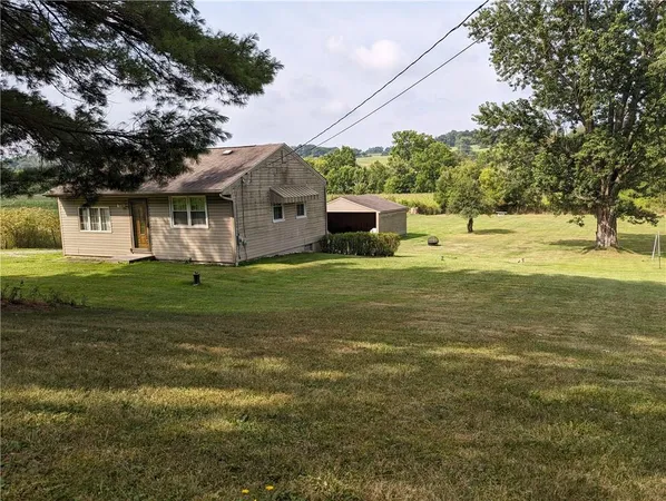 a house view with a sitting space and garden