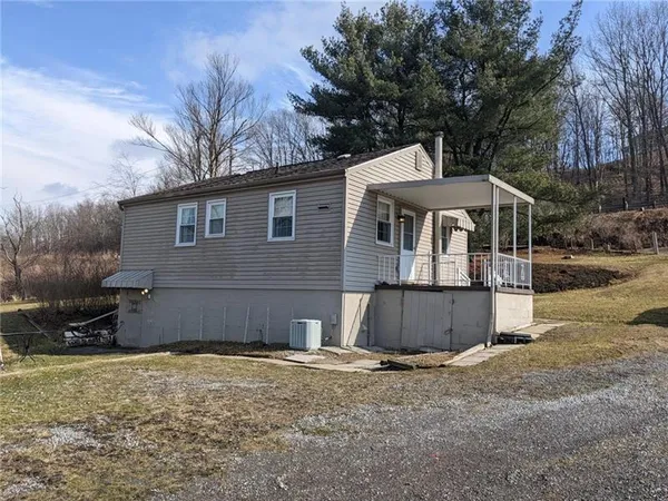 a view of a house with a yard covered with snow in the background