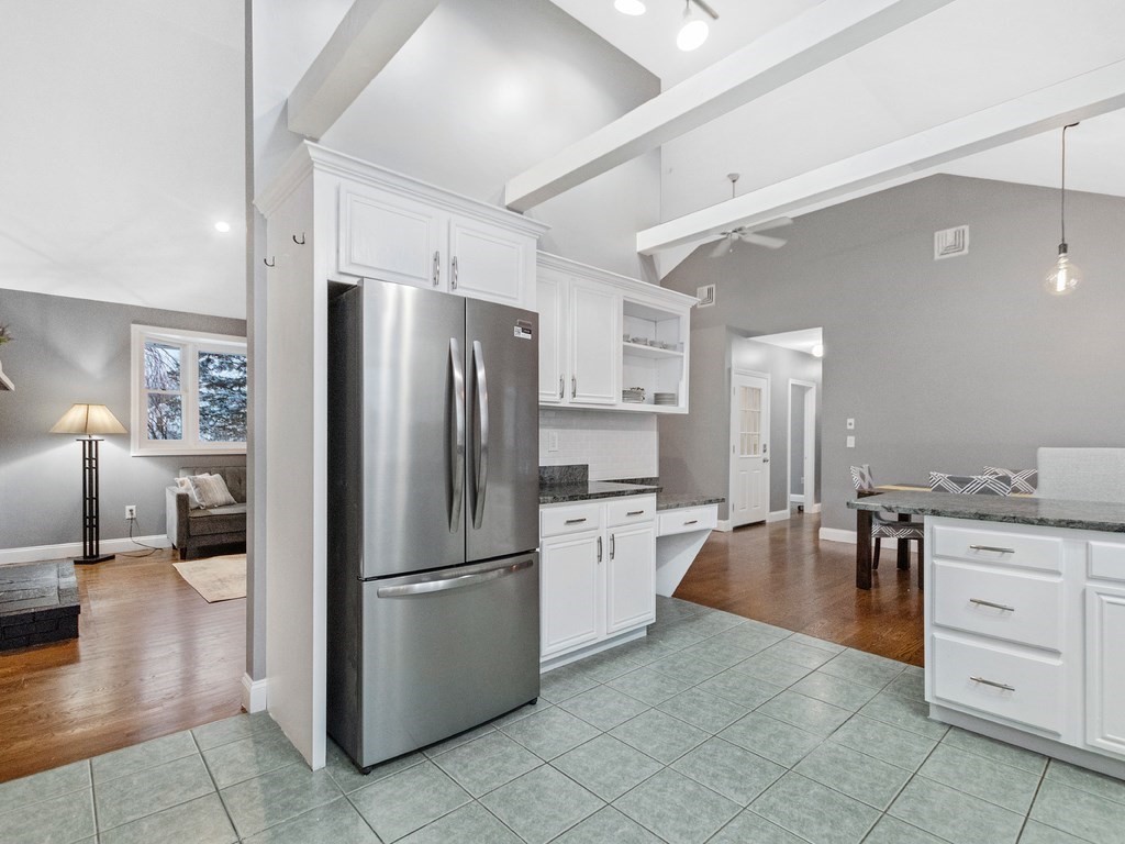 20 Indian Road Tewksbury, MA 01876 - Photo 11 of 30 a kitchen with white cabinets and stainless steel appliances