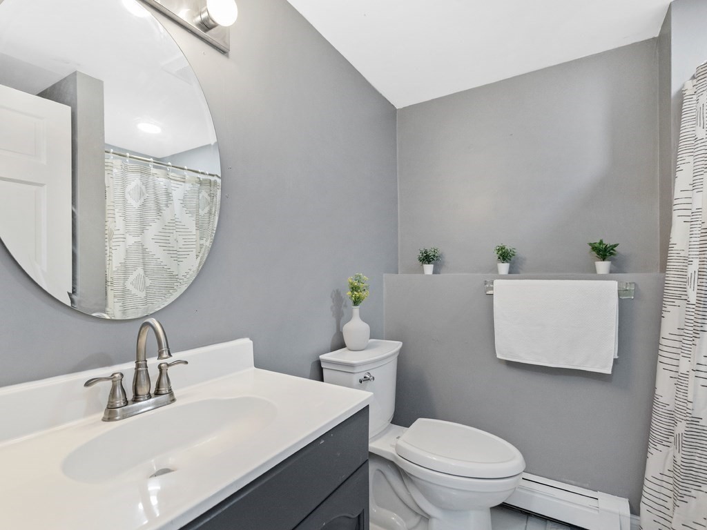 20 Indian Road Tewksbury, MA 01876 - Photo 22 of 30 a bathroom with a sink a toilet and a mirror