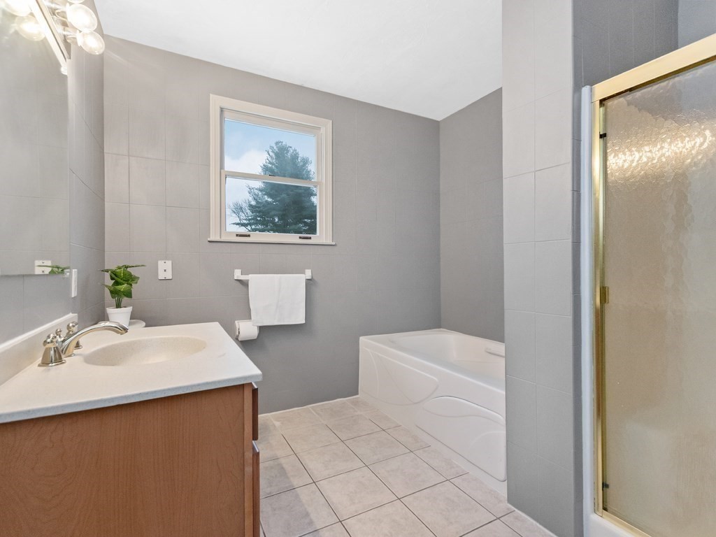 20 Indian Road Tewksbury, MA 01876 - Photo 24 of 30 a bathroom with a sink a toilet and mirror