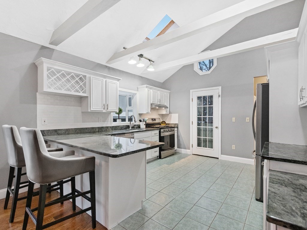 20 Indian Road Tewksbury, MA 01876 - Photo 9 of 30 a kitchen with stainless steel appliances granite countertop a stove and a refrigerator