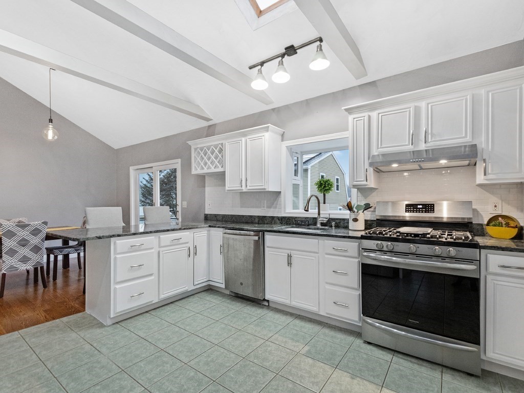 20 Indian Road Tewksbury, MA 01876 - Photo 10 of 30 a kitchen with granite countertop cabinets stainless steel appliances and a dining table