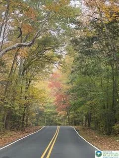 a view of a balcony with a yard