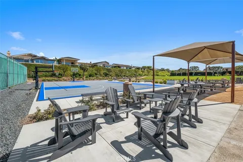 a view of a terrace with furniture and umbrella