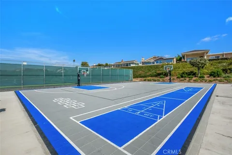 a view of a tennis ground with large trees