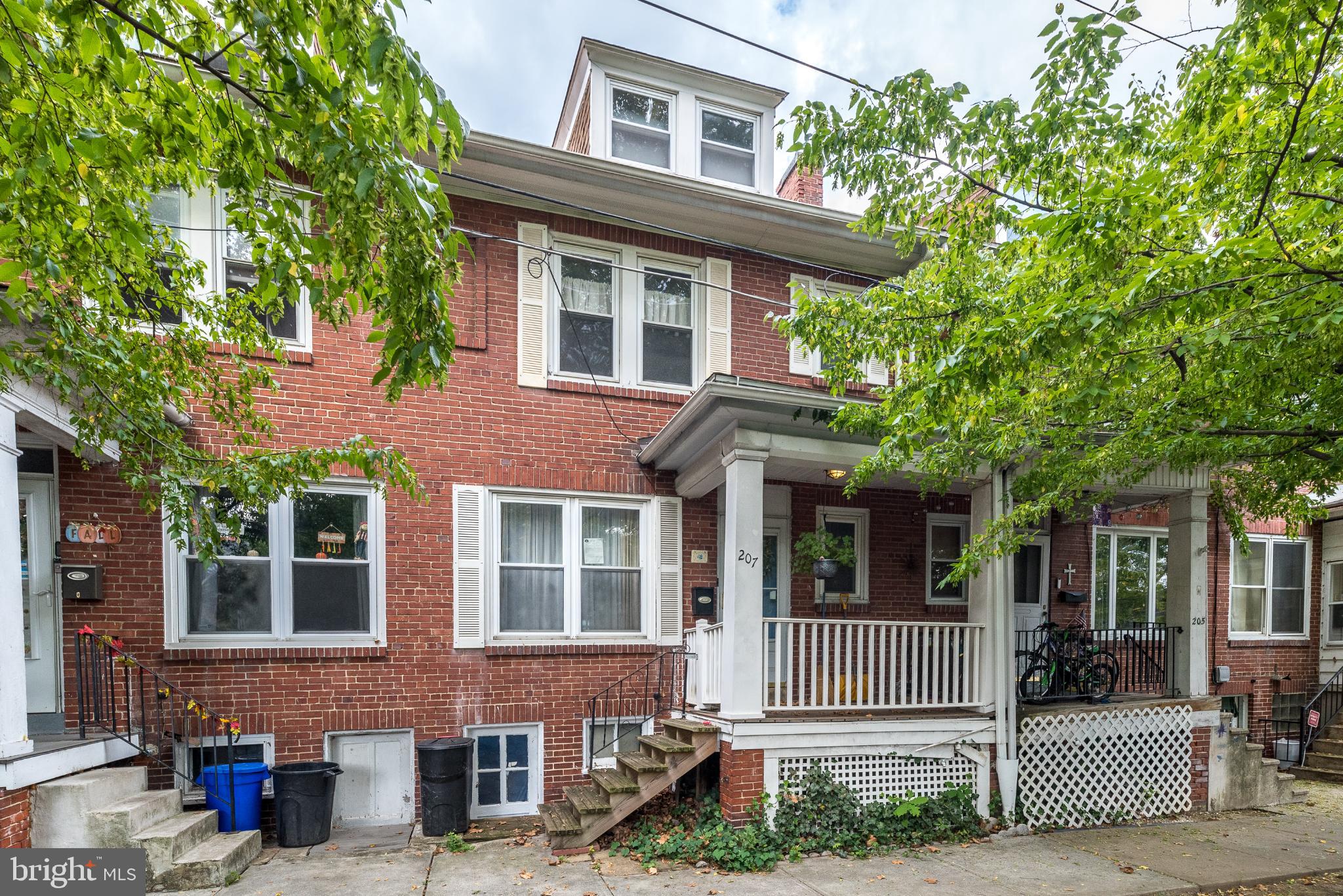 Charming brick facade with inviting porch.