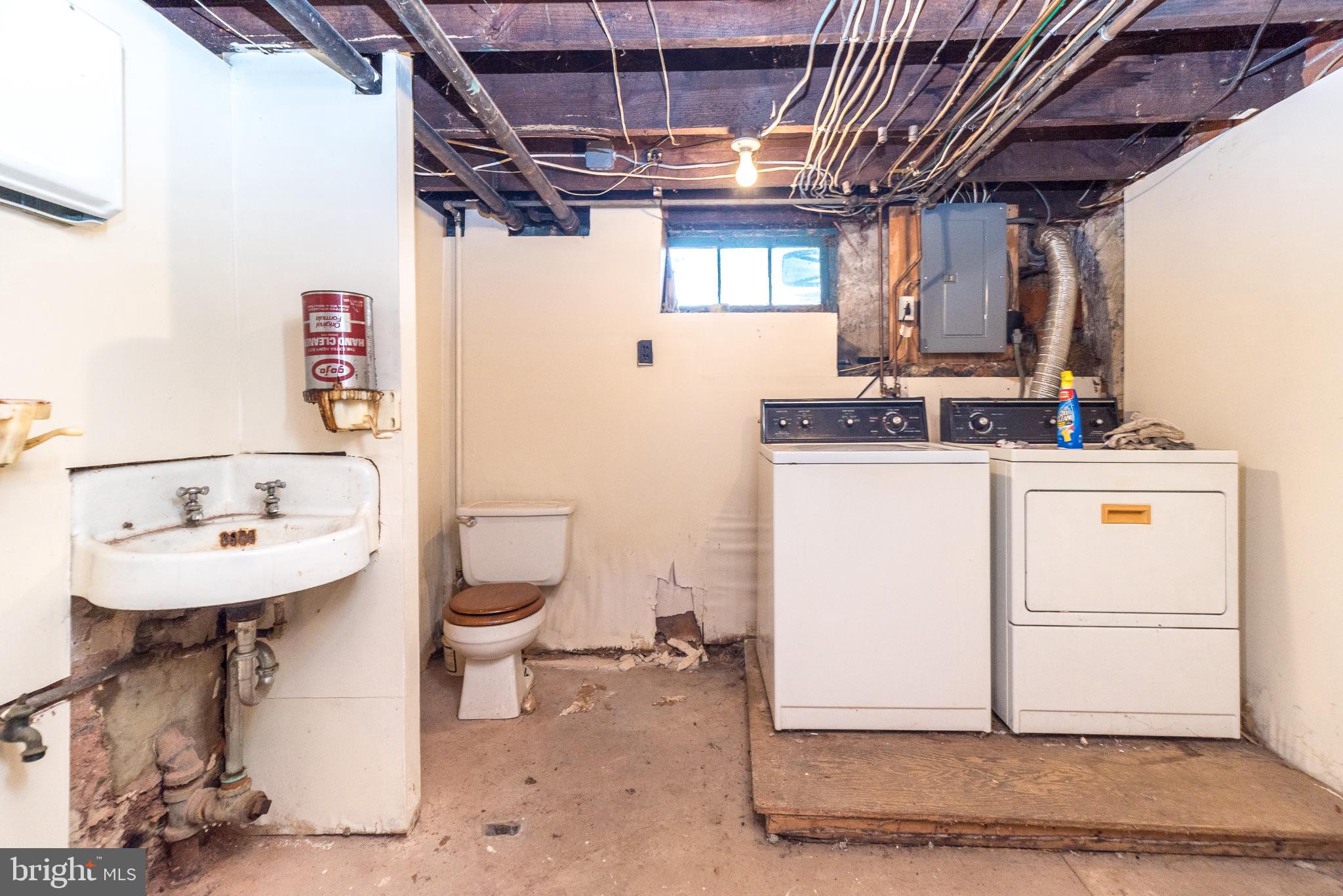 207 Spruce Street Reading, PA 19611 - Photo 23 of 23 Functional basement laundry area with utilities.