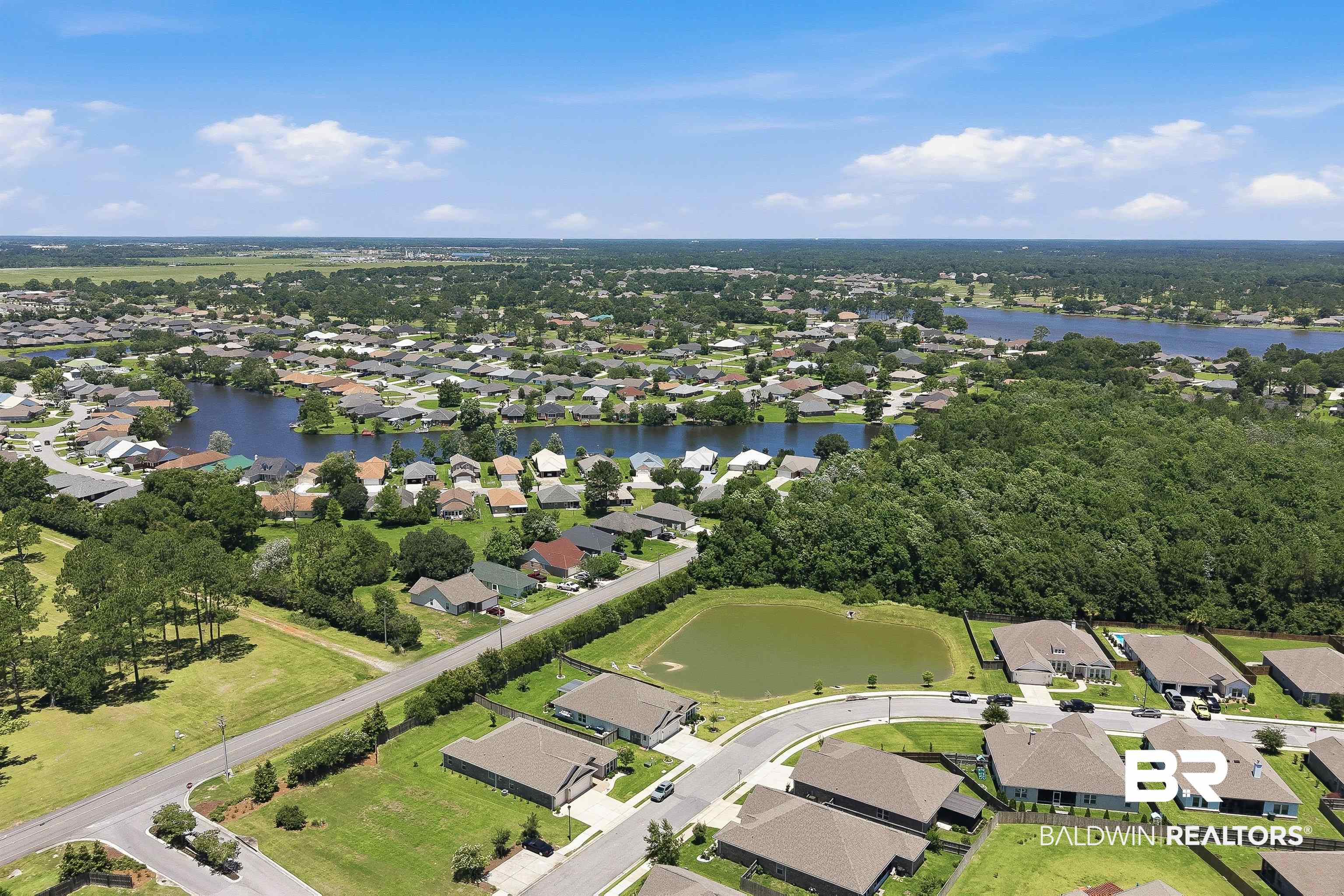 8735 Bronze Lane Foley, AL 36535 - Photo 53 of 58 Aerial perspective showcasing a residential community with multiple lakes and wooded areas