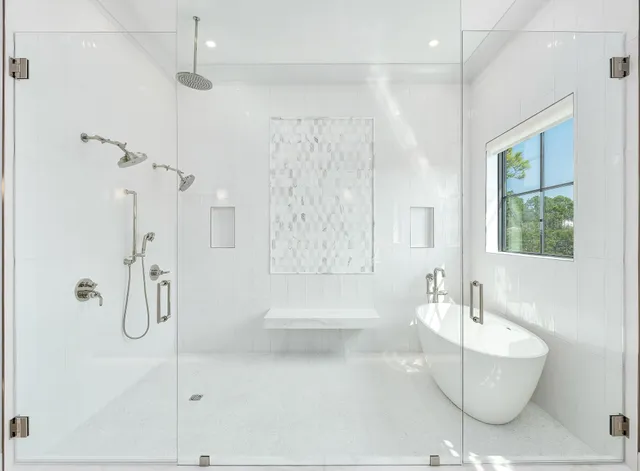 a bathroom with a double vanity sink a mirror and a bathtub