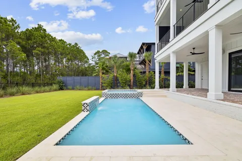 a view of swimming pool is middle in the garden
