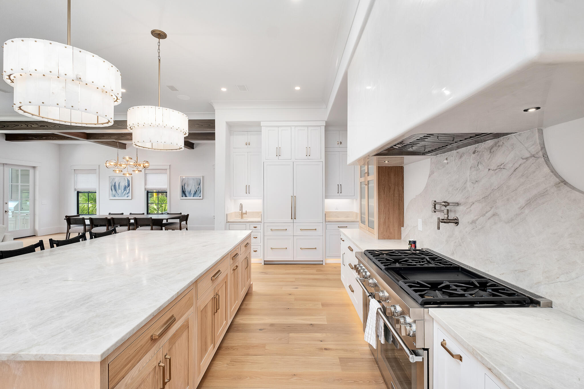 28 Loon Lake Drive Santa Rosa Beach, FL 32459 - Photo 4 of 23 a large kitchen with kitchen island a stove a sink a oven and a dining table with wooden floor