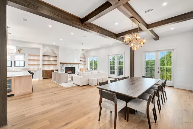 a view of a dining room with furniture wooden floor and chandelier