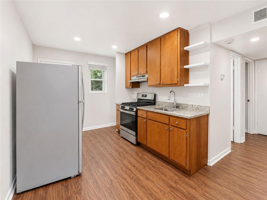 3203 East Point Street, Unit 4 Atlanta, GA 30344 - Photo 5 of 18 a kitchen with stainless steel appliances granite countertop a refrigerator and a stove top oven