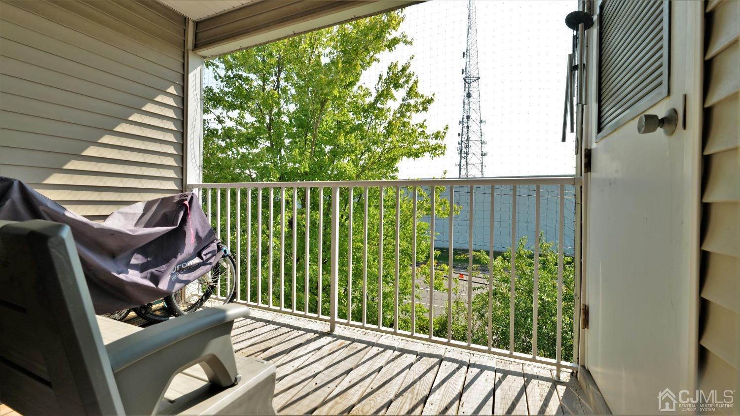1133 Edpas Road New Brunswick, NJ 08901 - Photo 21 of 26 a view of a balcony with chair and wooden floor