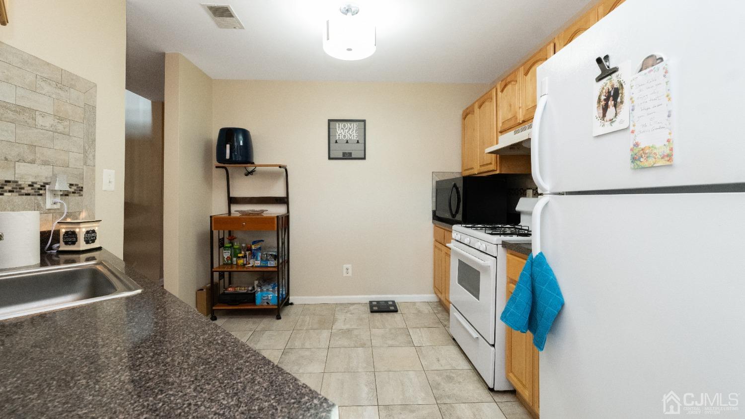1133 Edpas Road New Brunswick, NJ 08901 - Photo 6 of 26 a kitchen with stainless steel appliances granite countertop a refrigerator and a stove top oven