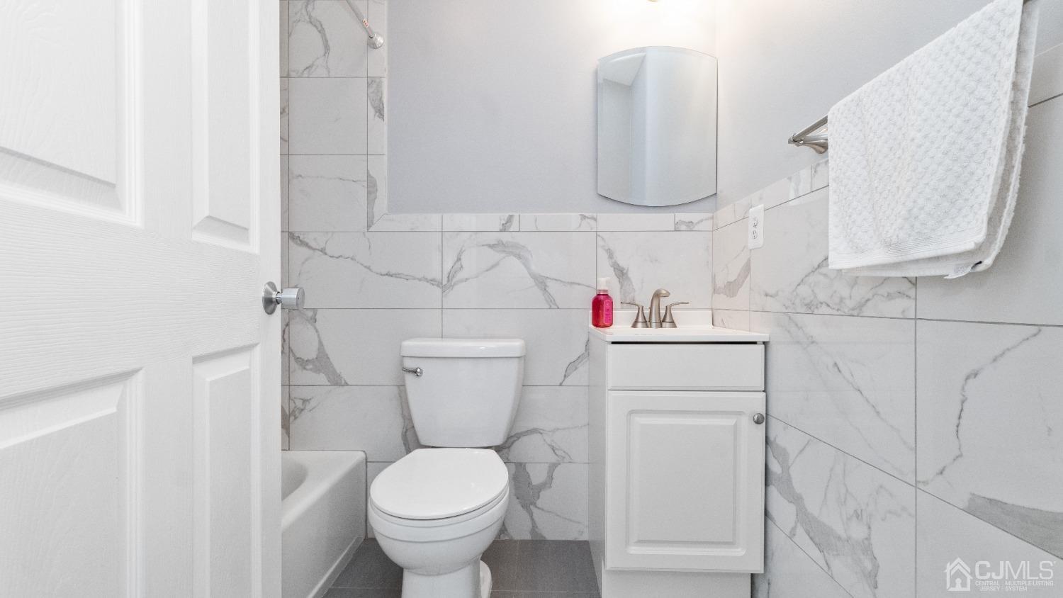 1133 Edpas Road New Brunswick, NJ 08901 - Photo 10 of 26 a bathroom with a toilet sink and vanity