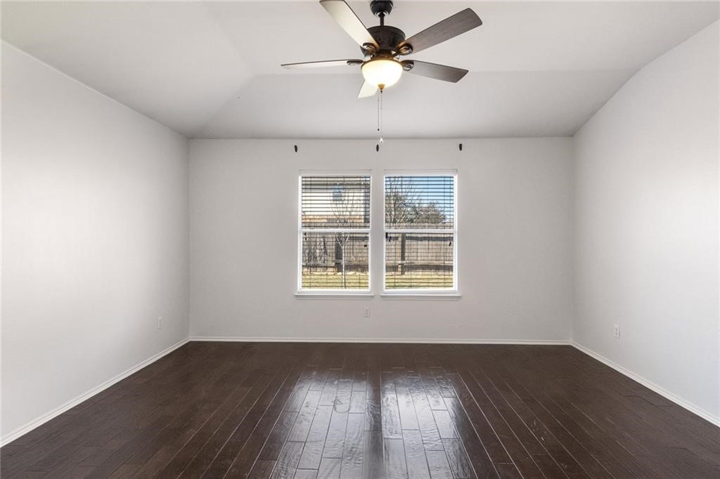 913 Cindy Lane Leander, TX 78641 - Photo 11 of 28 a view of an empty room with wooden floor and a window