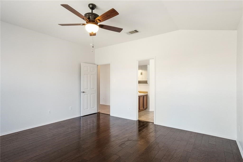 913 Cindy Lane Leander, TX 78641 - Photo 12 of 28 an empty room with wooden floor and ceiling fan