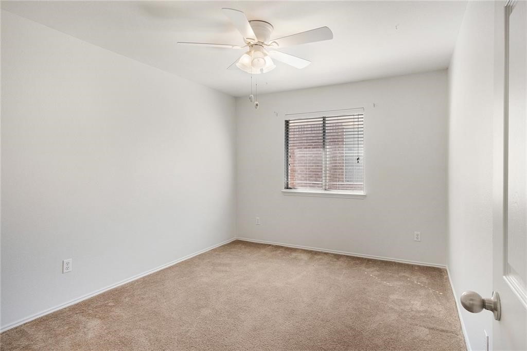913 Cindy Lane Leander, TX 78641 - Photo 18 of 28 an empty room with a chandelier fan and windows